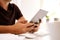 Man working on digital tablet sitting at work table