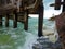 Man working fishing sea beach wave choppy rocks cliff edge