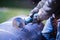 Man working with grinder saw, close up view on tool. Electric saw and hands of worker with sparks. Worker cutting metal