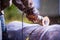 Man working with grinder saw, close up view on tool. Electric saw and hands of worker with sparks. Worker cutting metal