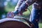 Man working with grinder saw, close up view on tool. Electric saw and hands of worker with sparks. Worker cutting metal