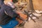 Man working with grinder saw, close up view on tool. Electric saw and hands of worker with sparks. Worker cutting metal with