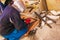 Man working with grinder saw, close up view on tool. Electric saw and hands of worker with sparks. Worker cutting metal with