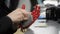 Man is working with hand bionic prosthesis, sitting at table indoors.