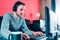 Man working from his couch at home with a computer, headphones.