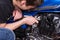 Man Working on his Motorbike Using Wrench Tool