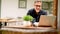 Man working with laptop computer at home outdoor on terrace