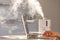 Man working on laptop near the humidifier on the table