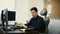 Man working in office in front of desktop computer