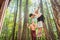 Man working out on the rings, his girlfriend cheering at him