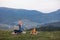 Man working outdoors with laptop sitting in mountains. Concept of remote work or freelancer lifestyle. Cellular network broadband