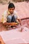 Man working on a piece of sandstone outside Taj Mahal complex in