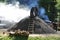 Man working on smoking charcoal-kiln