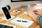 Man working at table while mobile phone and smartwatch charging with wireless device