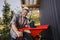 Man working with a wheel of a grape harvesting machine to squeeze many grapes