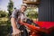 Man working with a wheel of a grape harvesting machine to squeeze many grapes