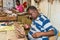 Man Working on Wood Sailing Ship Model