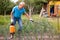 Man works with garden spray in the yard