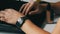 A man works at laptop. Men`s hands with a smart watch and an electronic cigarette are typing on the keyboard.