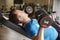 Man works out with dumbbells on a bench at a gym, side view