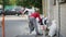 Man works with shovel and puts remains of cement chips into a polypropylene bag