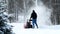 Man works with a snow blower to remove newly fallen snow from driveway