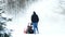 Man works with a snow blower to remove newly fallen snow after storm.