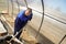 A man works in a vegetable garden in early spring. Digs the ground. Working in a greenhouse