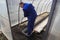 A man works in a vegetable garden in early spring. Digs the ground. Working in a greenhouse