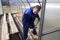 A man works in a vegetable garden in early spring. Digs the ground. Working in a greenhouse