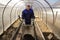 A man works in a vegetable garden in early spring. Digs the ground. Working in a greenhouse