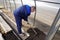 A man works in a vegetable garden in early spring. Digs the ground. Working in a greenhouse