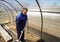 A man works in a vegetable garden in early spring. Digs the ground. Working in a greenhouse