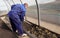 A man works in a vegetable garden in early spring. Digs the ground. Working in a greenhouse