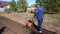 A man works in a vegetable garden in early spring. Digs the ground. Works as a cultivator, walk-behind tractor