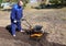 A man works in a vegetable garden in early spring. Digs the ground. Works as a cultivator, walk-behind tractor