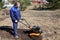 A man works in a vegetable garden in early spring. Digs the ground. Works as a cultivator, walk-behind tractor