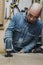 man in workshop cutting wood with a jig saw