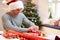 Man Wrapping Christmas Gifts At Home