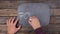 Man writes the word FORGING with chalk on a chalkboard, stylized as a thought.