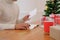 man writing christmas letter greeting card holiday wishes with x