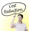 Man writing `Cost Reduction`