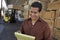 Man Writing On Notepad With Worker Working In Forklift At Warehouse