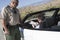 Man Writing On Ticket With Traffic Officer Standing By Car