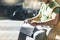 Man with yellow backpack holding smartphone, tourist looking map city on background taxi, hipster planning route using in hands