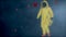 Man in a yellow hazmat suit walks through futuristic viruses. Man with bacteriological protection suit. Coronavirus, SARS-nCOV-2,