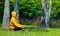 Man in yellow hoodie is relaxingly practicing meditation in the forest to attain happiness from inner peace wisdom for healthy