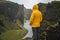 Man in yellow jacket visit the Fjadrargljufur Volcanic Canyon in Iceland on moody overcast and rainy day