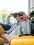 A man with yellow luggage. Handsome Asian male in denim shirt sitting and waiting and thinking while holding suitcase.