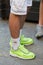 Man with yellow Nike sneakers and white socks with rainbow before Palm Angels fashion show, Milan